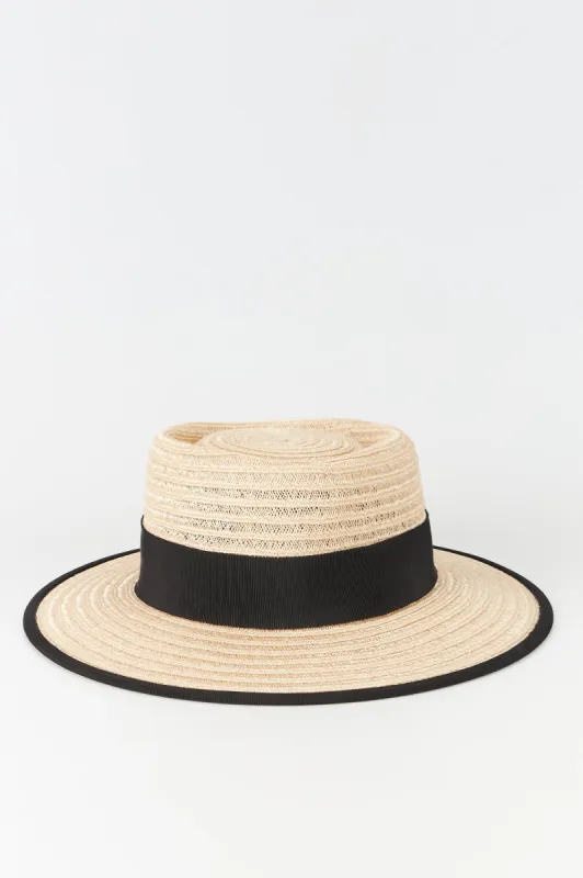 Natural straw hat with black band sold by DESTREE