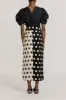 Black & white pencil skirt with circular pockets and button details sold by DESTREE