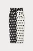 Black & white pencil skirt with circular pockets and button details sold by DESTREE