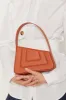 RUST Asymmetric Leather Quilted Mini Bag sold by DESTREE