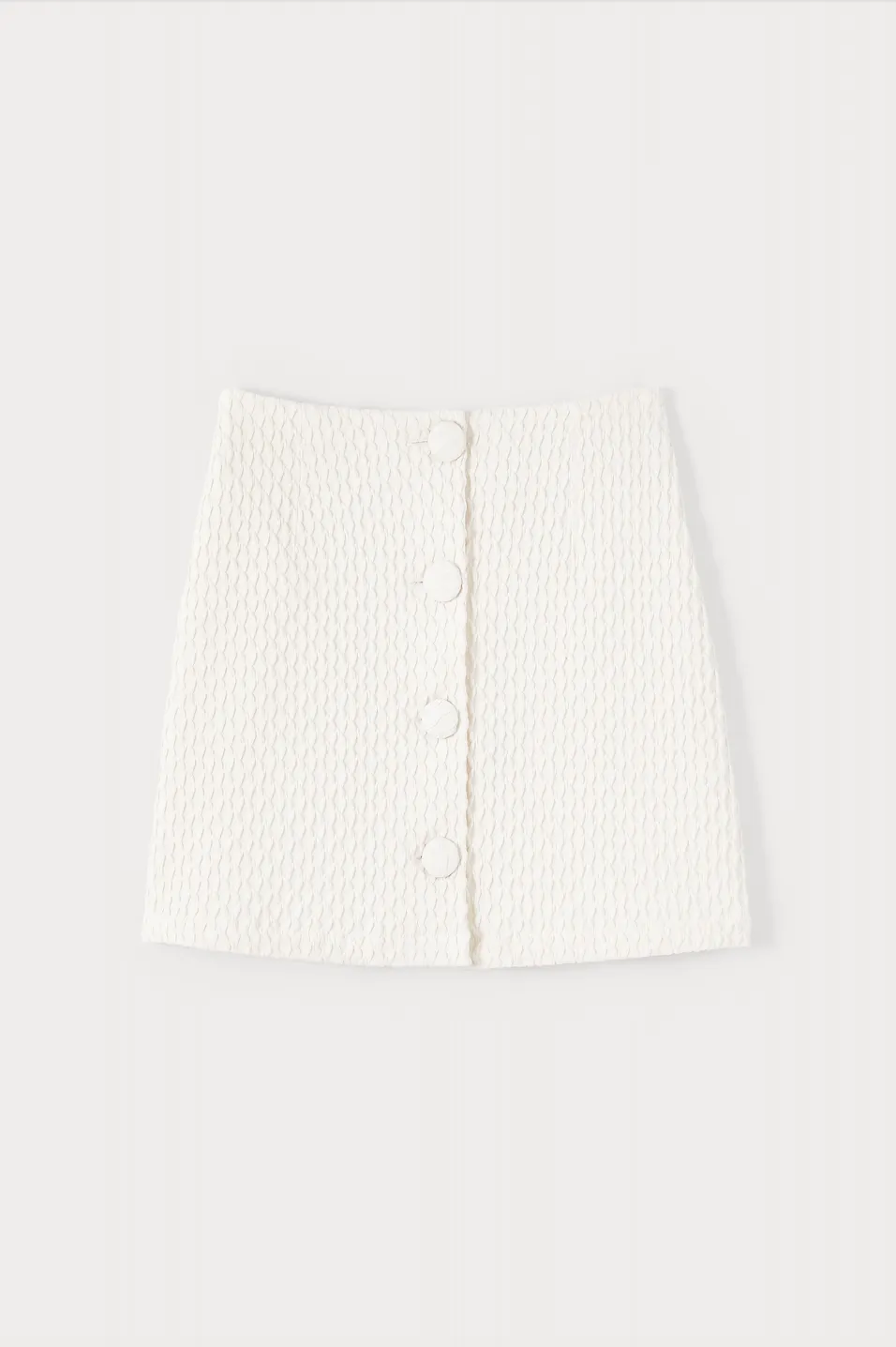 Ecru textured mini skirt with buttons sold by DESTREE