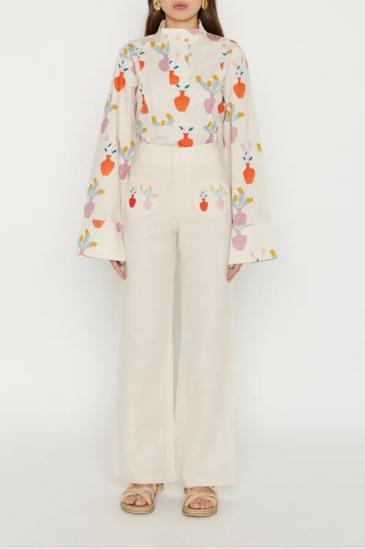 Ecru floral embroidered flared pants sold by DESTREE