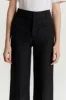 Black flared pants with circular pocket detail sold by DESTREE