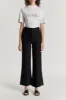 Black flared pants with circular pocket detail sold by DESTREE