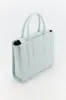 Light blue leather structured tote sold by DESTREE