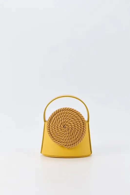 Yellow leather mini bag with passementerie details sold by DESTREE