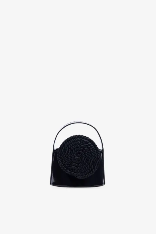 Black mini patent leather bag with passementerie details sold by DESTREE