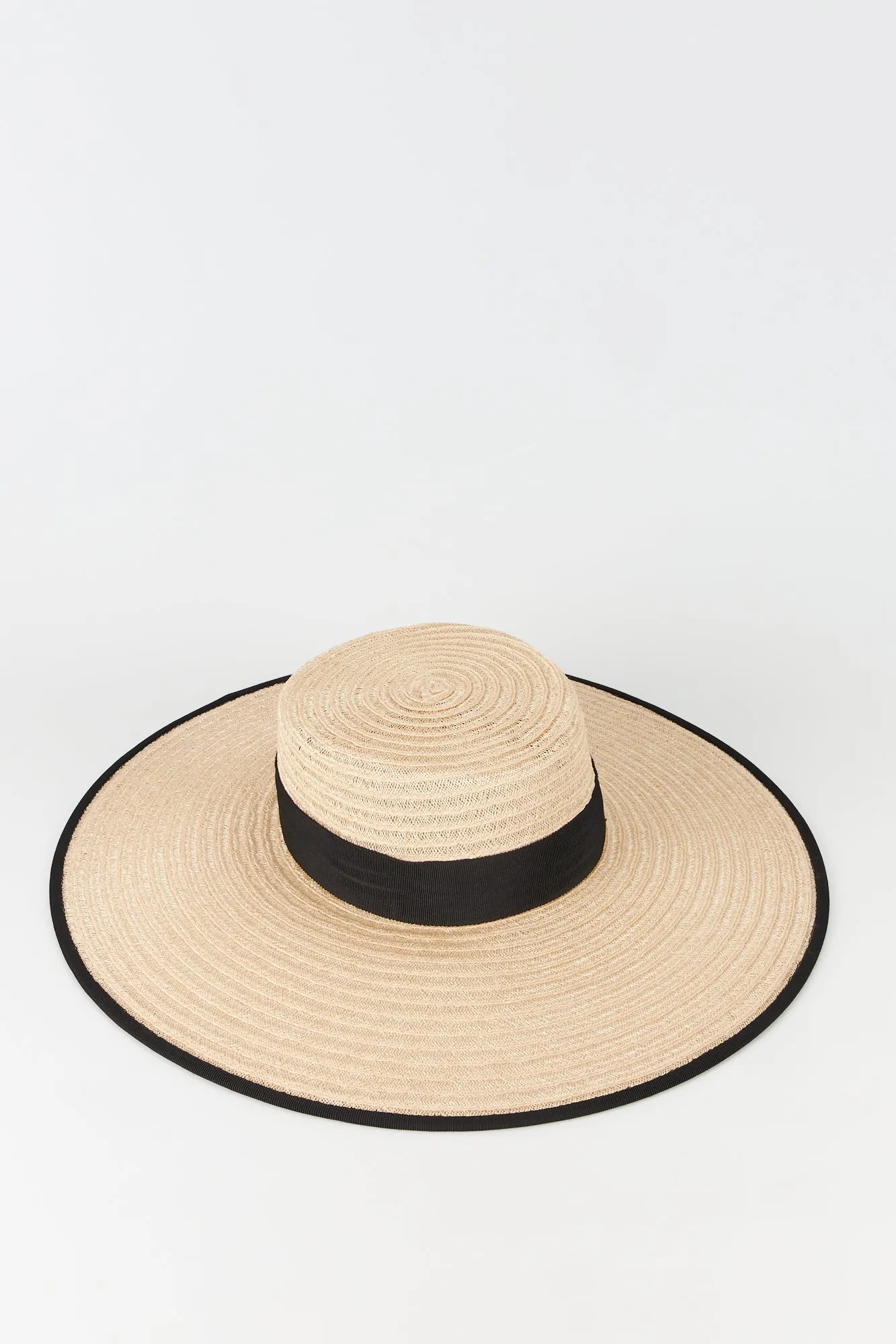 Natural straw hat with black band sold by DESTREE