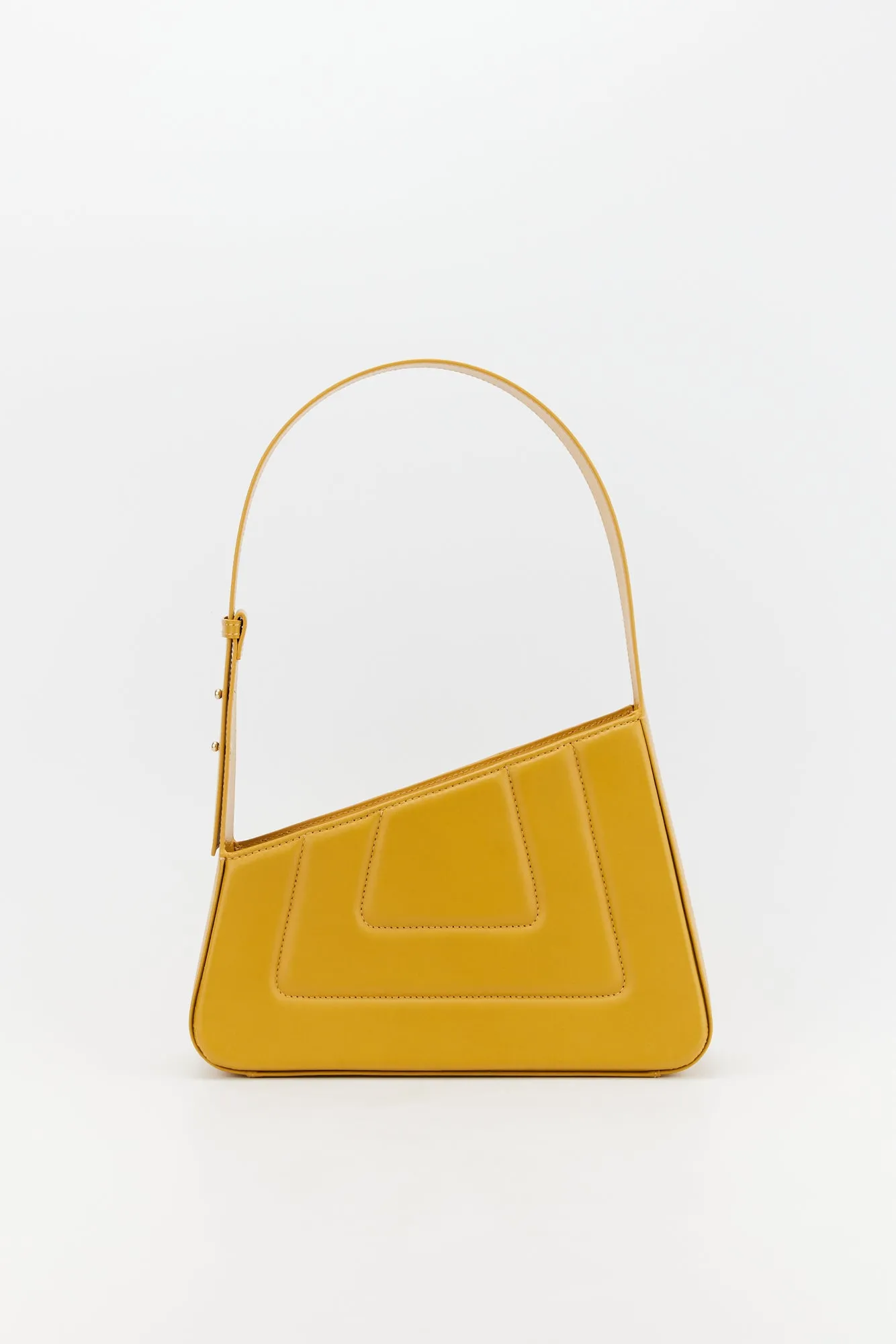 Mustard asymmetric leather quilted bag sold by DESTREE