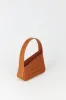 Tobacco asymmetric leather quilted mini bag sold by DESTREE