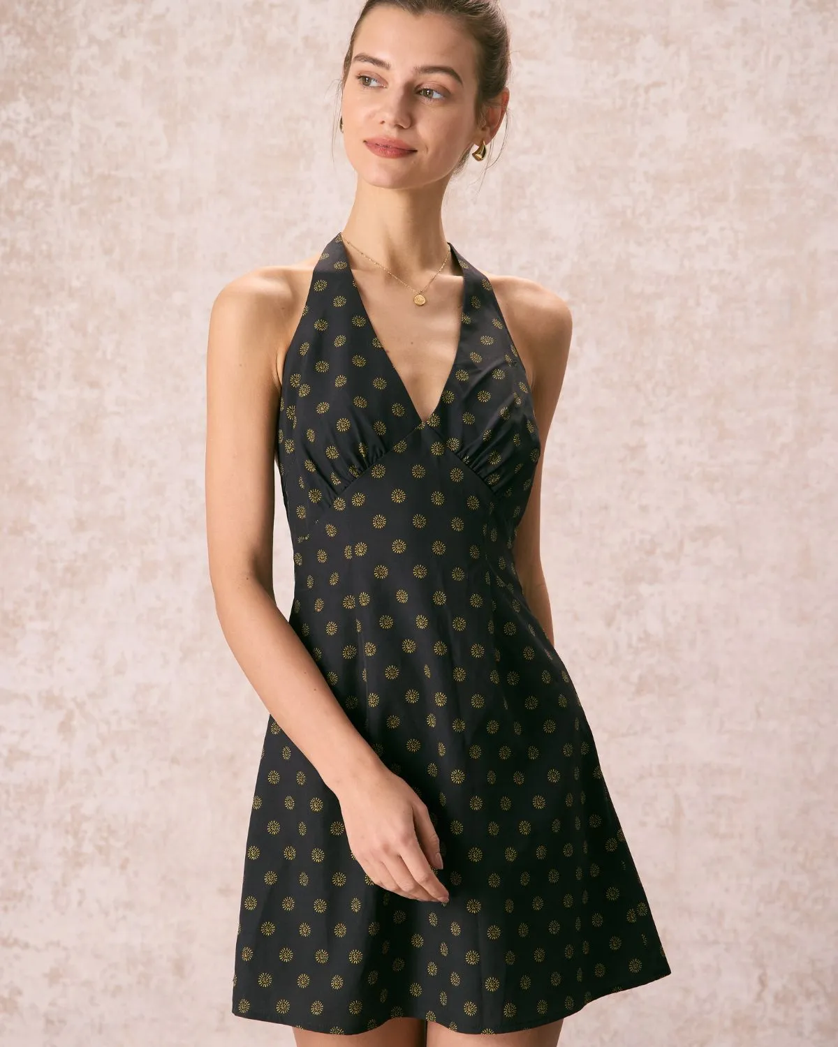 The Black Halter Floral A-Line Mini Dress sold by rihoas