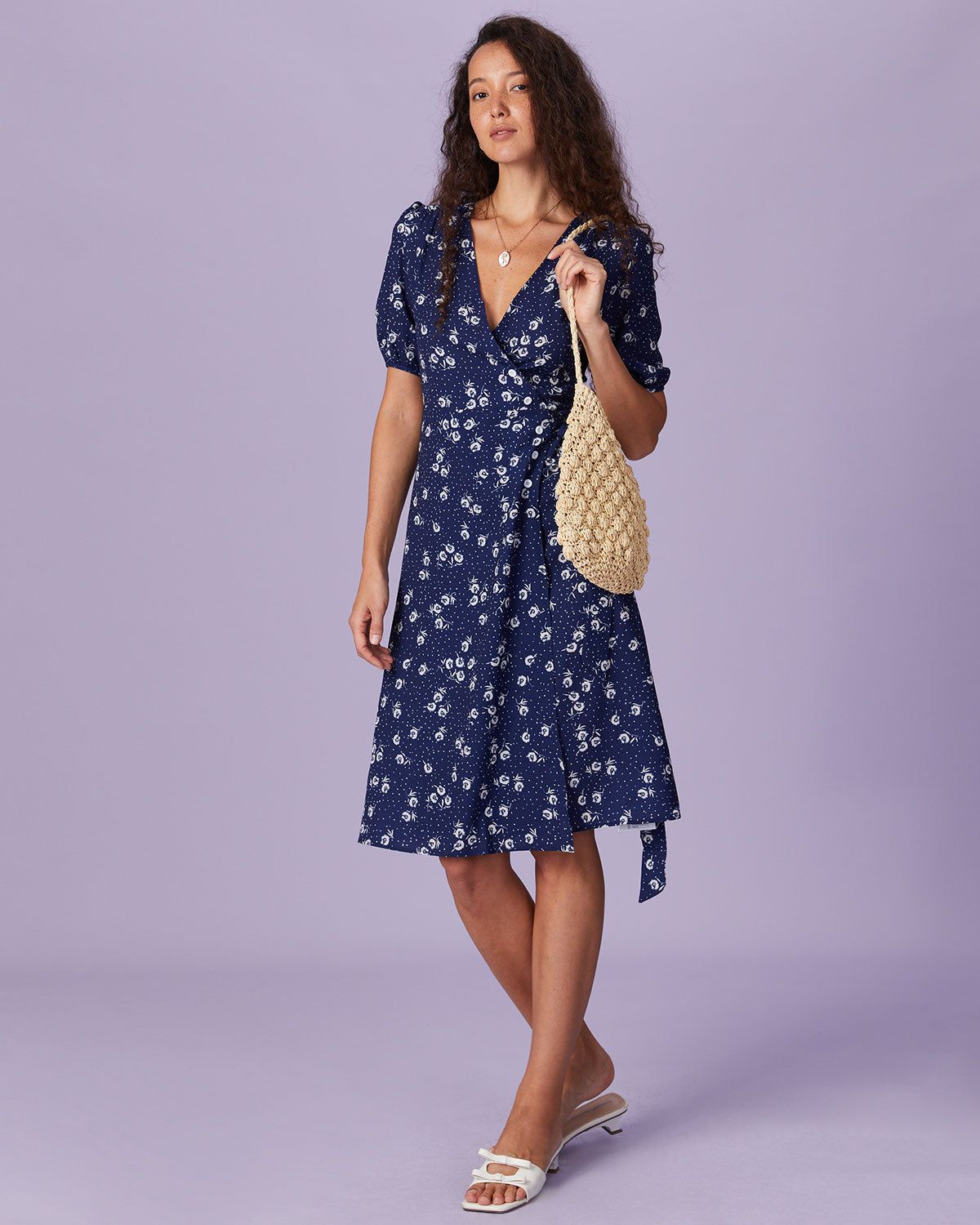 The Navy V Neck Floral Button Wrap Midi Dress sold by rihoas