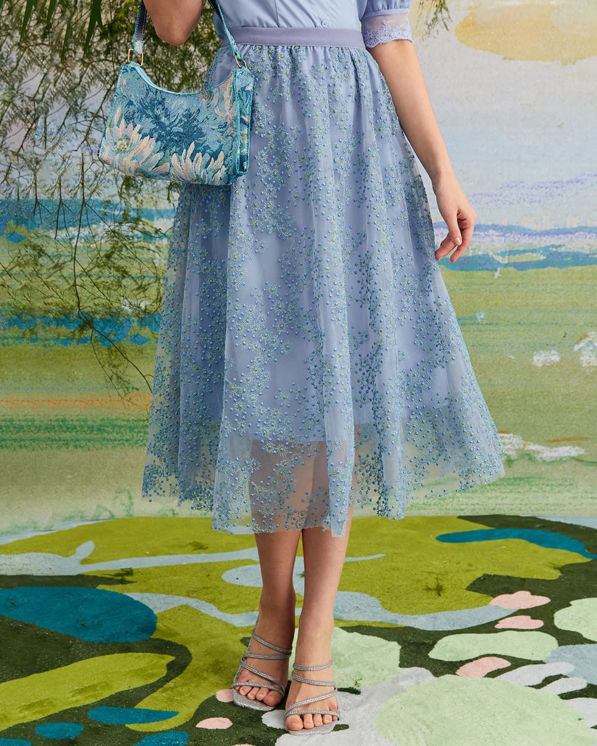 The Blue Embroidered Floral Mesh Midi Skirt sold by rihoas