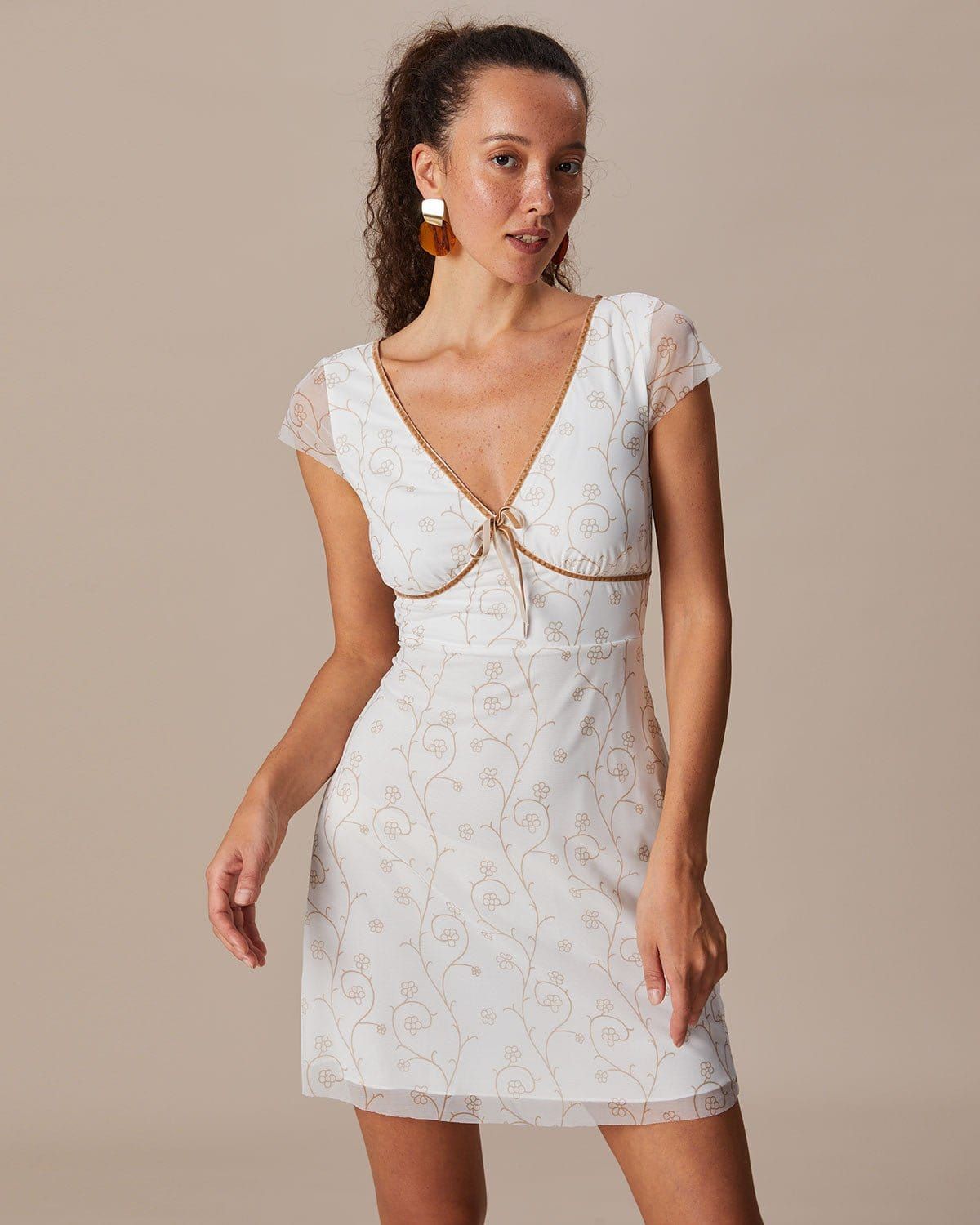 The White V Neck Floral Contrasting Mini Dress sold by rihoas