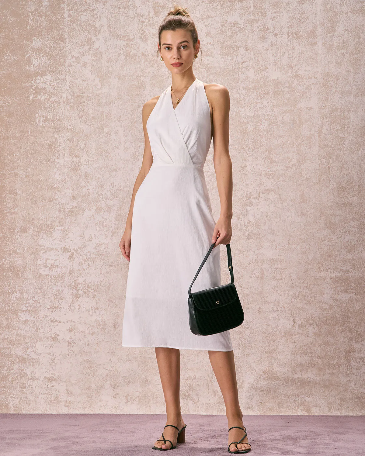 The White Halter Ruched Wrap Satin Midi Dress sold by rihoas