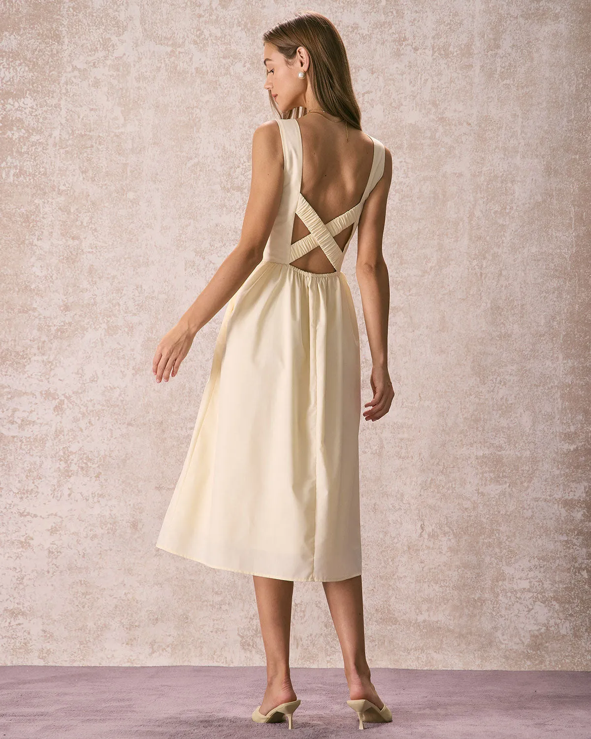 The Light Yellow Pleated Cross Back Midi Dress sold by rihoas