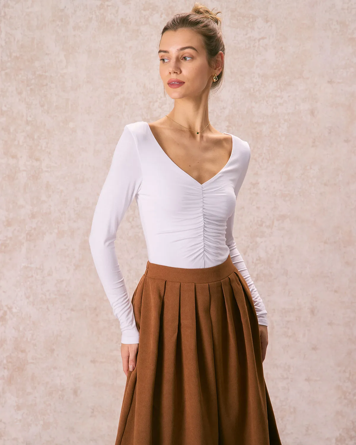 The White V Neck Ruched Long Sleeve Tee sold by rihoas