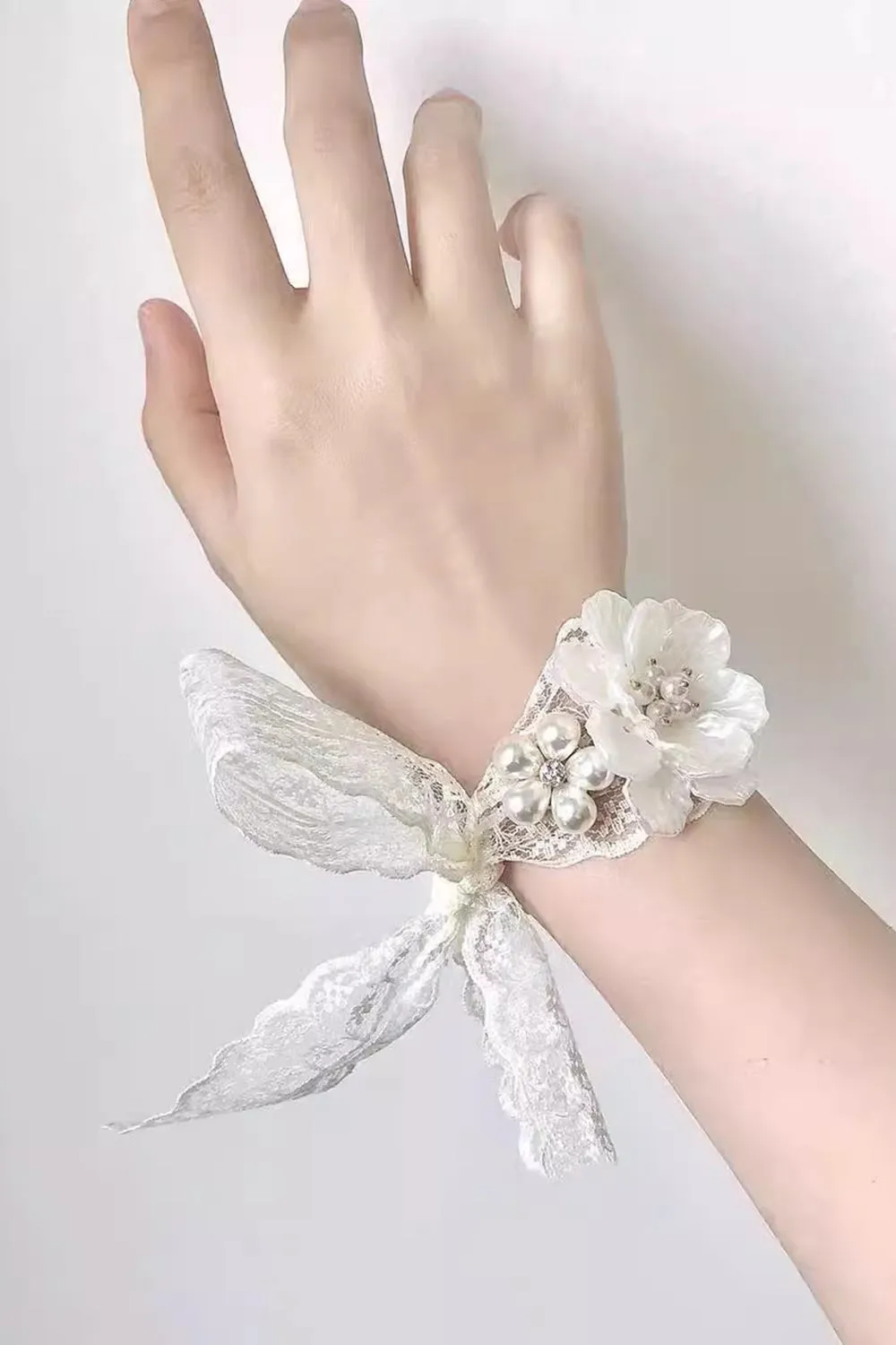 White Ceramic Flower Wrist Corsage with Lace Ribbon sold by Zapaka