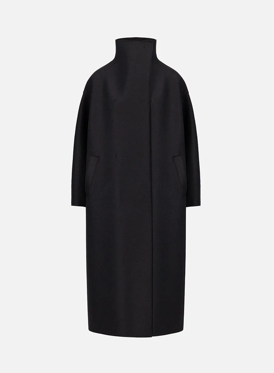 Funnel neck oversized coat in pressed wool sold by Harris Wharf London