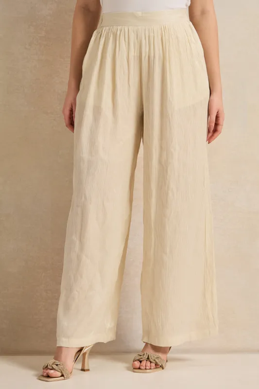 Women Cream Shimmer Crinkle Trouser sold by Redtag
