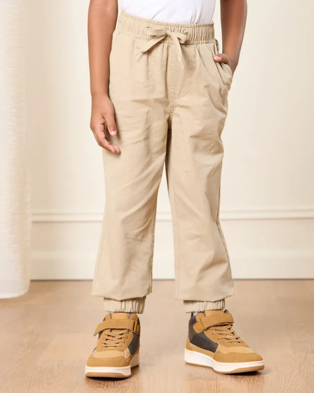 Boys Beige Solid Joggers sold by Redtag