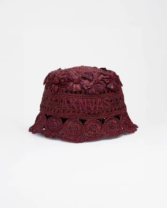 The Cass raffia bucket hat in wine made by Aknvas
