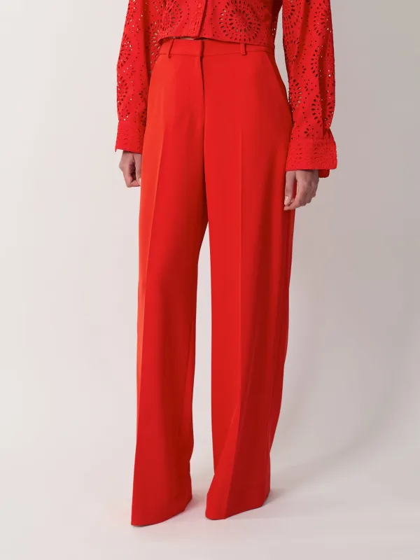 The Elin trousers in red made by Aknvas