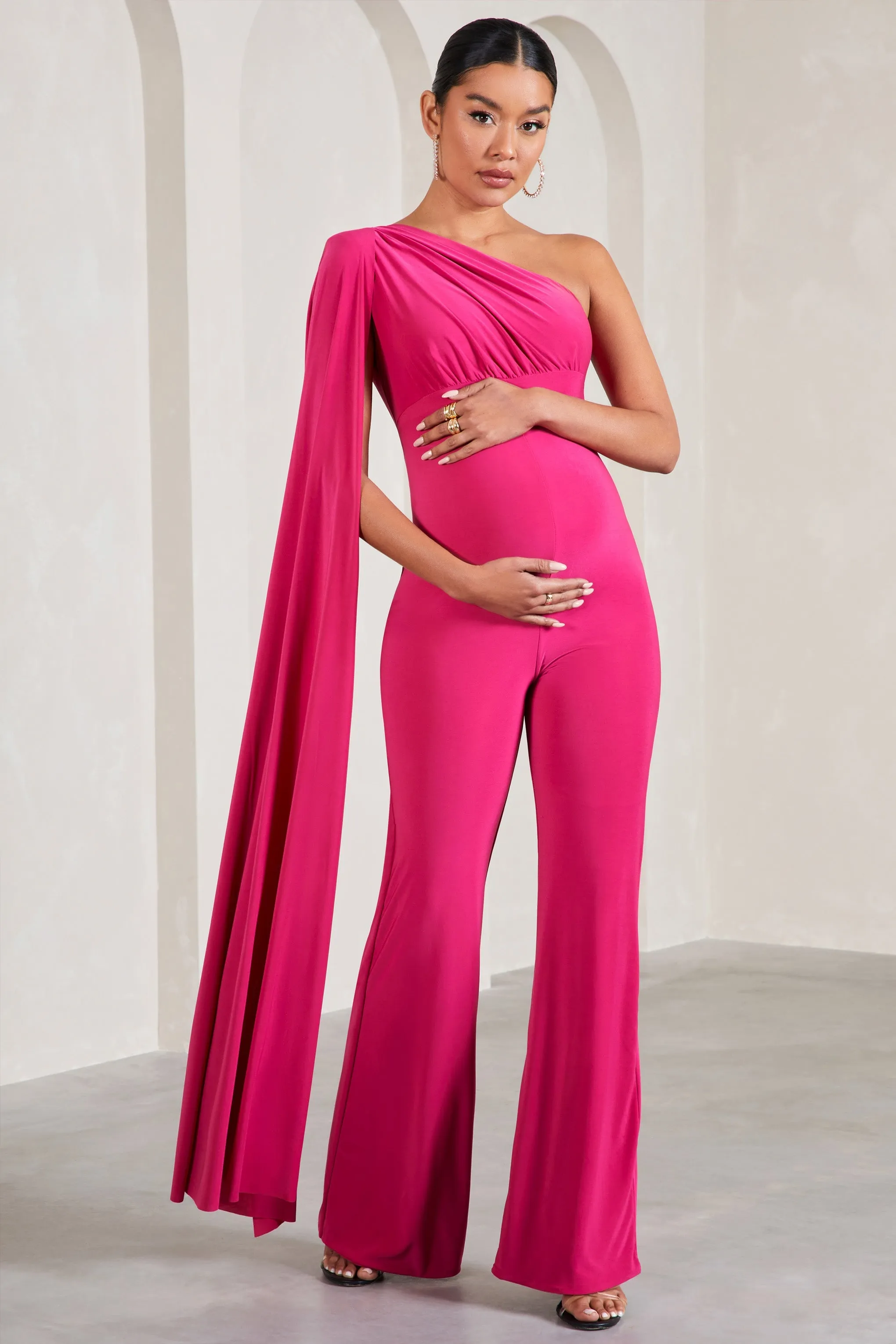 Sing To Sleep | Hot Pink Maternity One Shoulder Cape Jumpsuit sold by Club L London