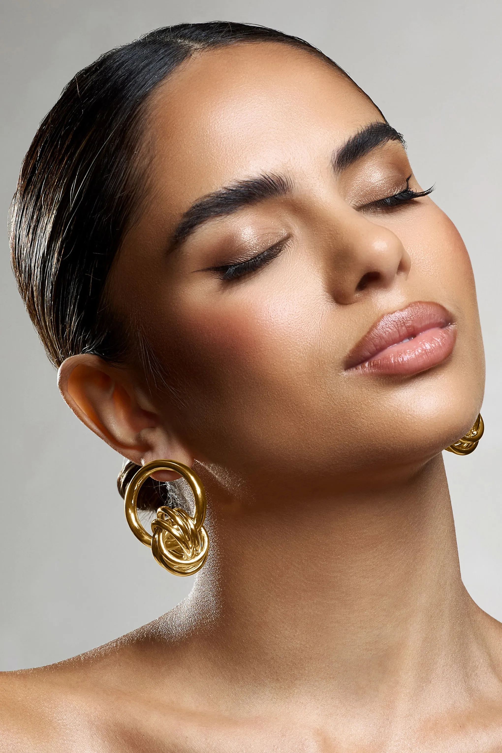 Tied Down | Gold Knot Dangle Earrings sold by Club L London product image thumbnail 3