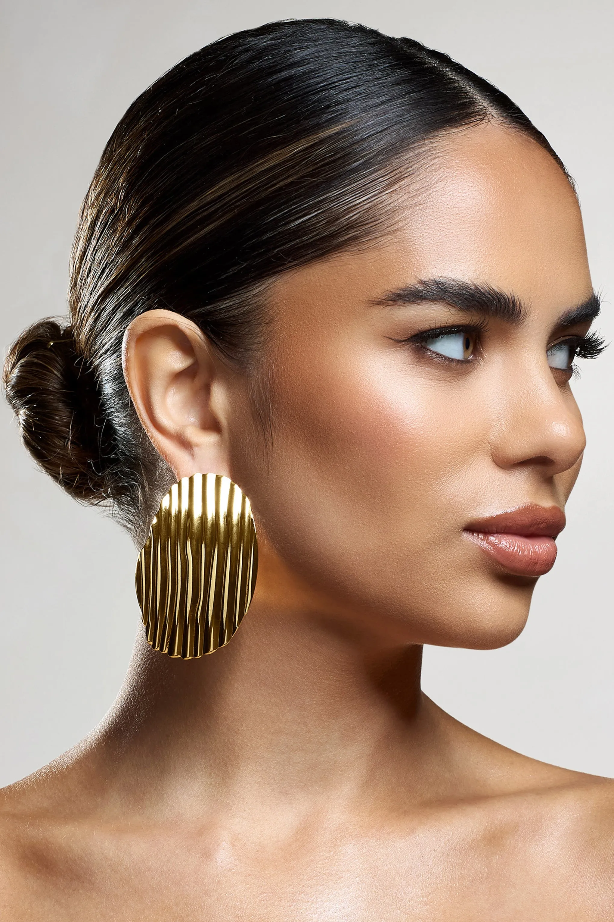 Sarla | Gold Textured Ribbed Statement Oval Earrings sold by Club L London