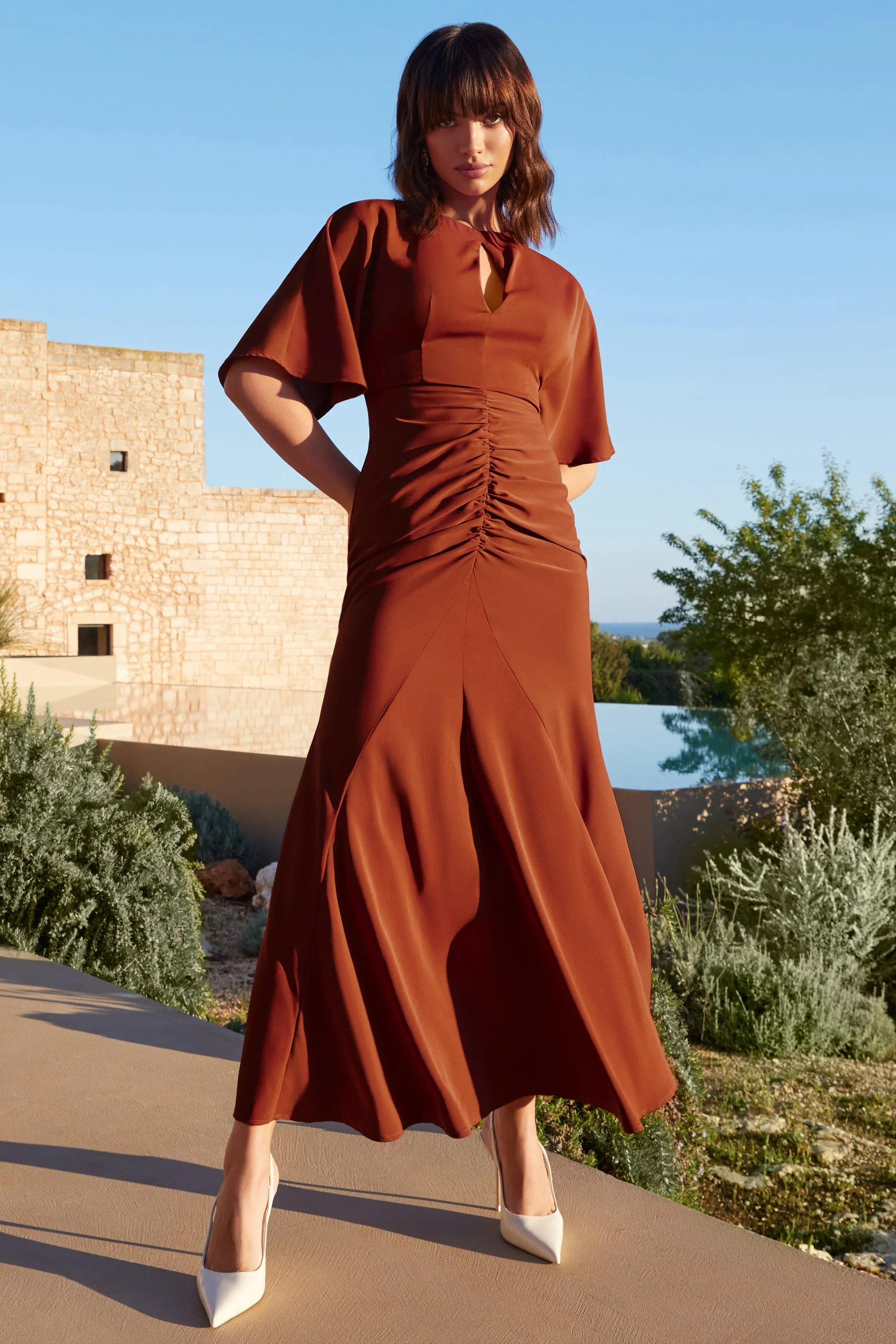 Elidy | Terracotta Ruched Flutter-Sleeve Cut-Out Maxi Dress sold by Club L London