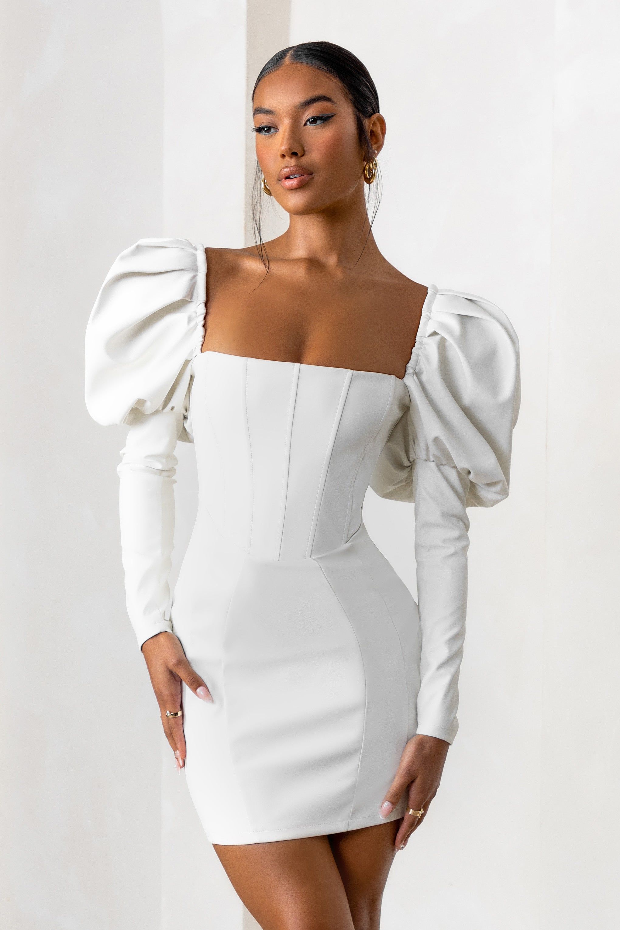 Karyme | Off White Faux Leather Puff Sleeve Mini Dress With Corset Detail sold by Club L London