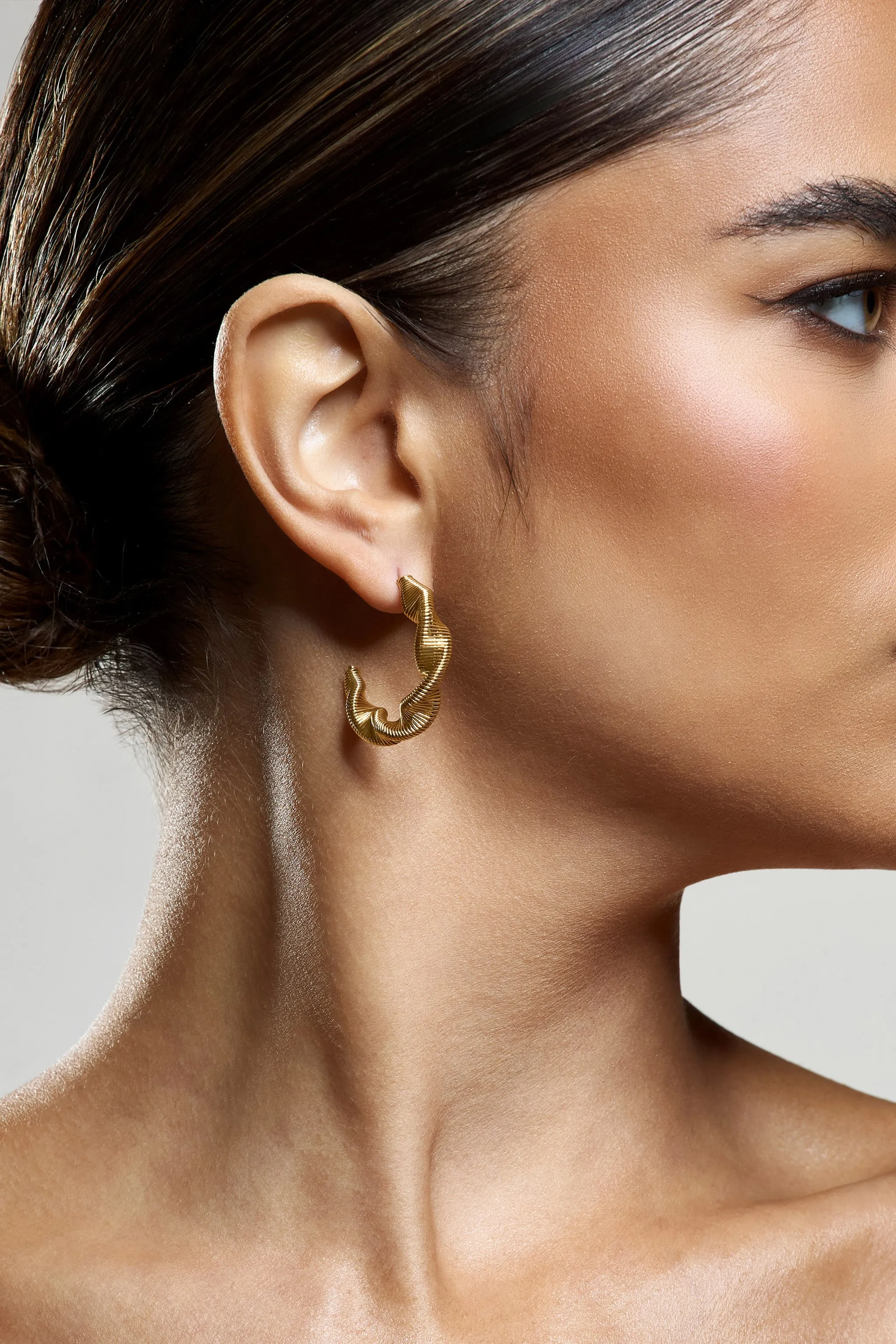 Carli | Gold Twist Hoop Earrings sold by Club L London product image thumbnail 4