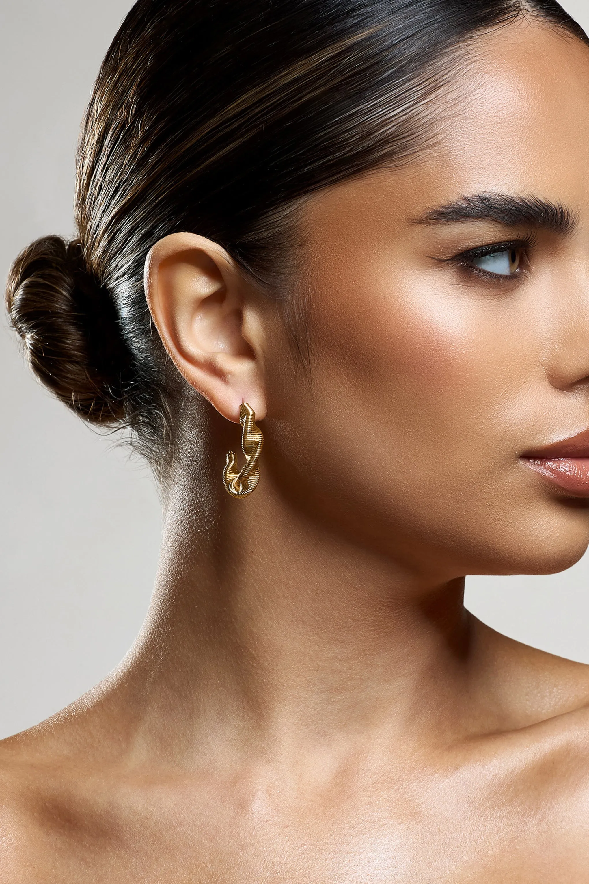 Carli | Gold Twist Hoop Earrings sold by Club L London product image thumbnail 3