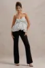 Divina | White & Black Polka Dot Strapless Ruffled Jumpsuit sold by Club L London