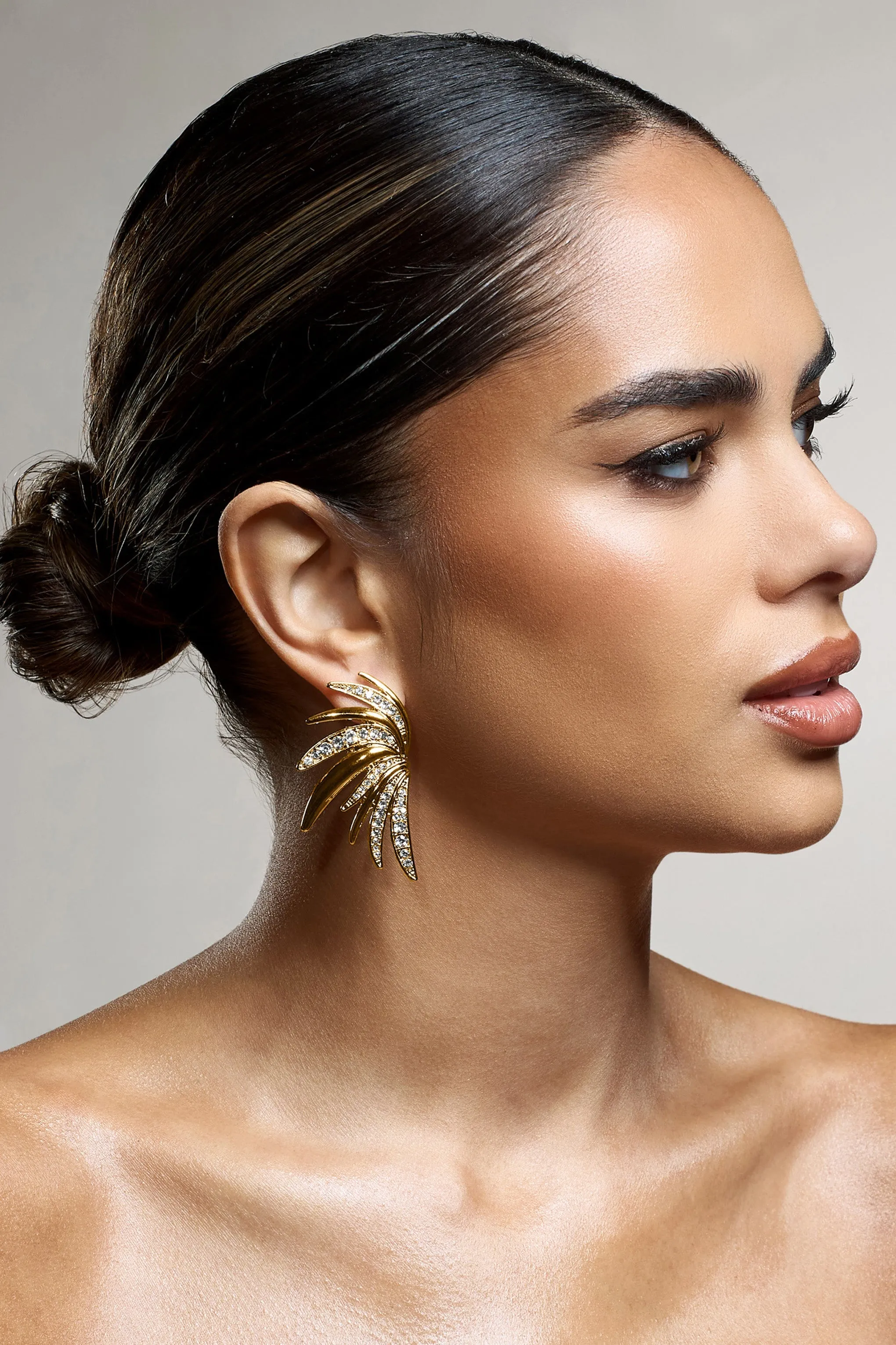 Curious | Gold Diamante Half Leaf Earrings sold by Club L London