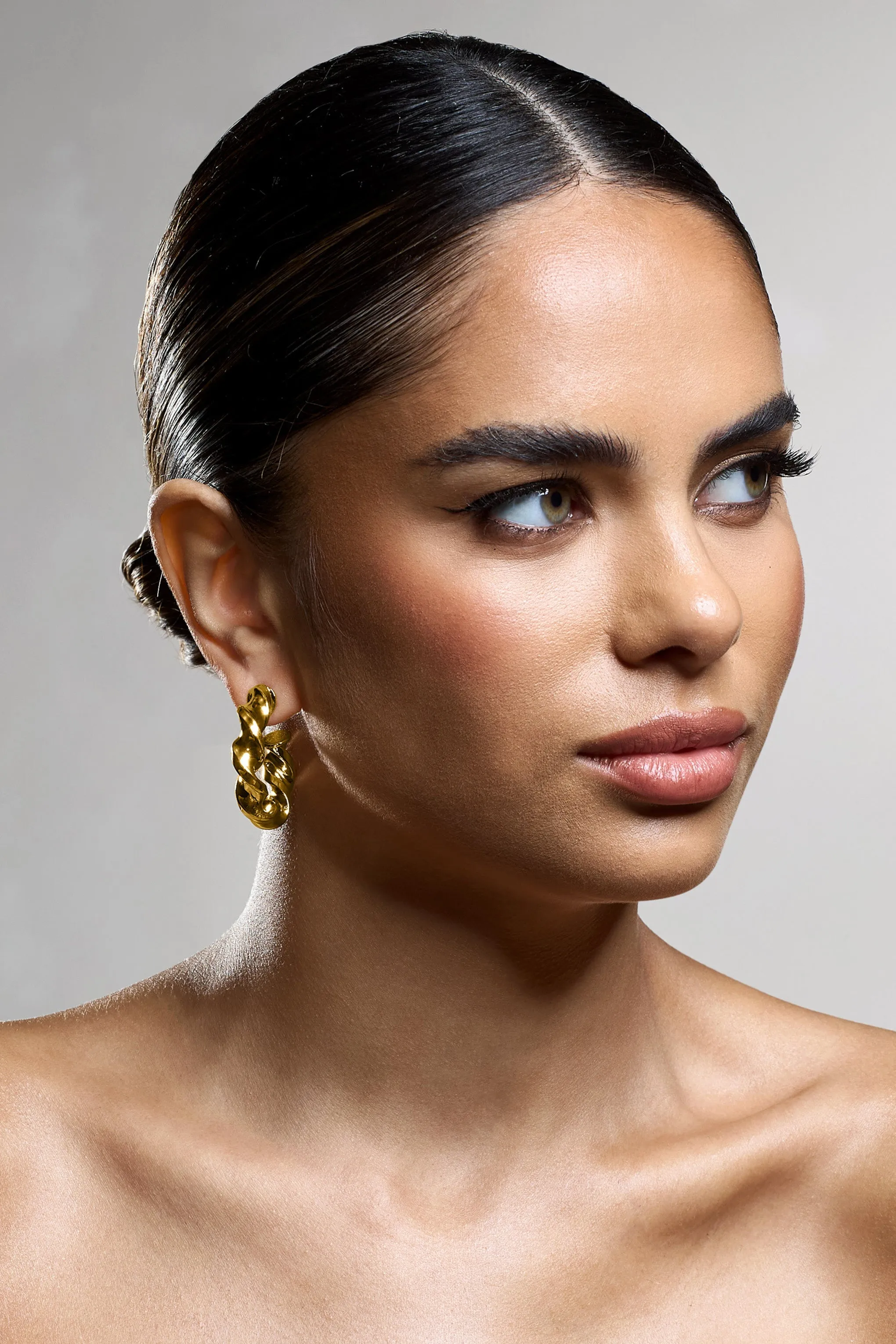 Greta | Gold Twisted Hoop Earrings sold by Club L London