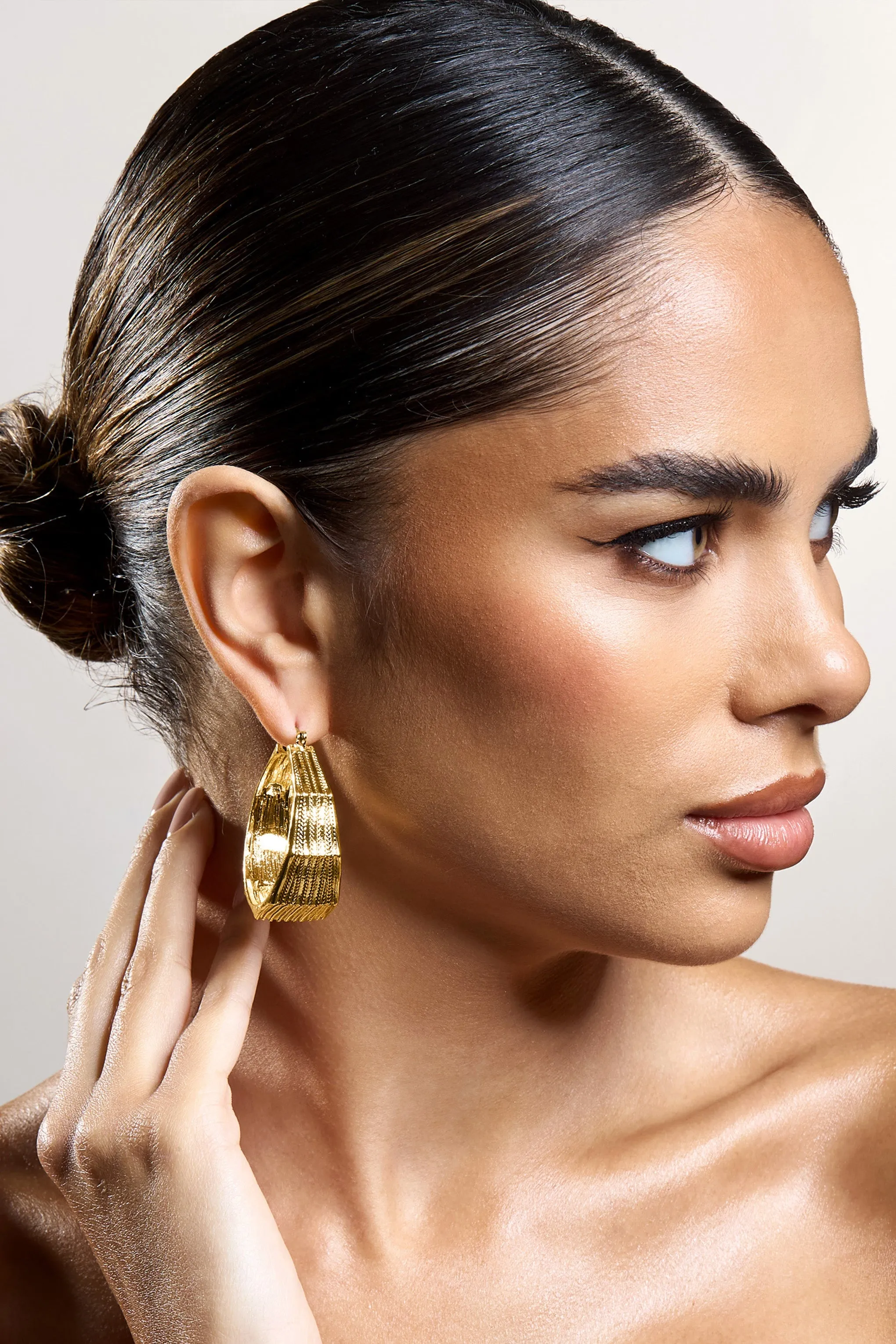 Meg | Gold Ribbed Hoop Earrings sold by Club L London product image thumbnail 3