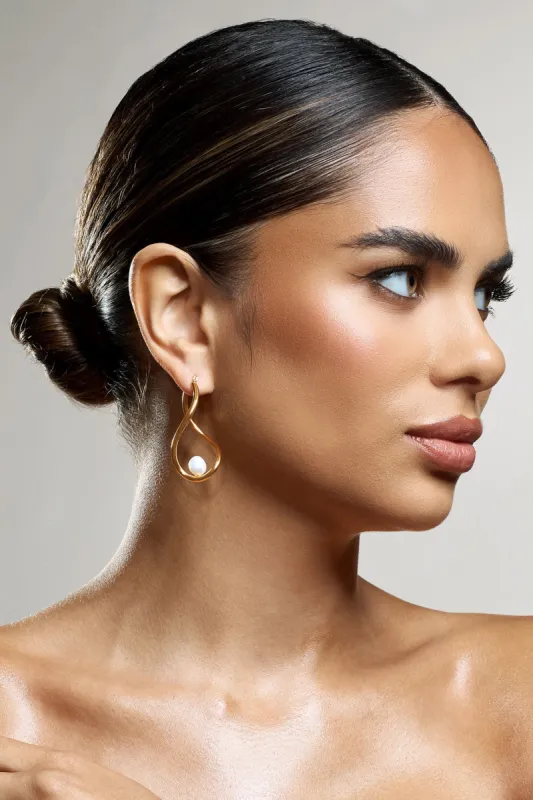 Louise | Gold Pearl Twisted Hoop Earrings sold by Club L London