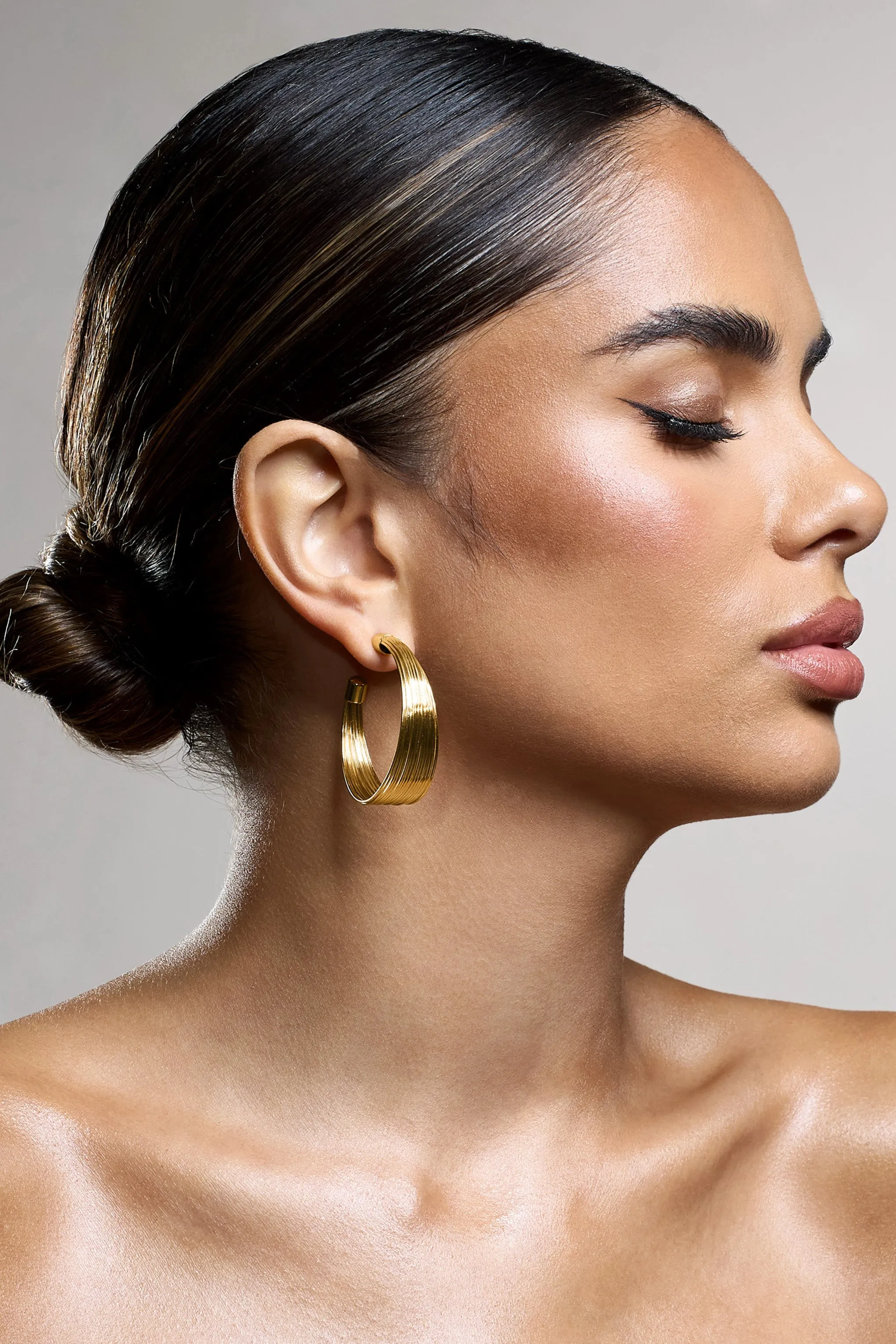Stori | Gold Layered Hoop Earrings sold by Club L London