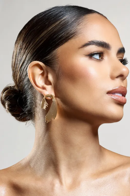 Marcela | Gold Ribbed Abstract Dangle Earrings sold by Club L London