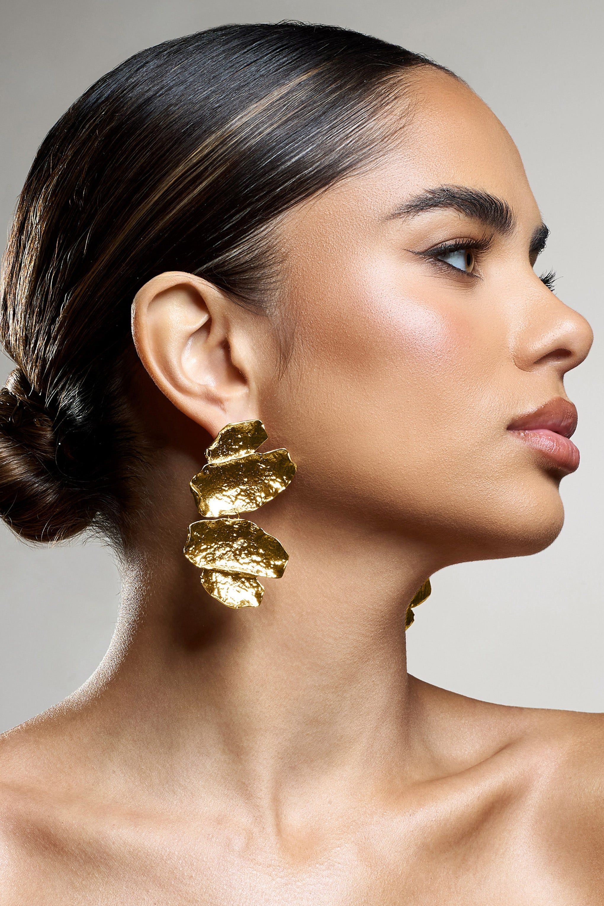 Sierra Madre | Gold Textured Abstract Drop Earrings sold by Club L London