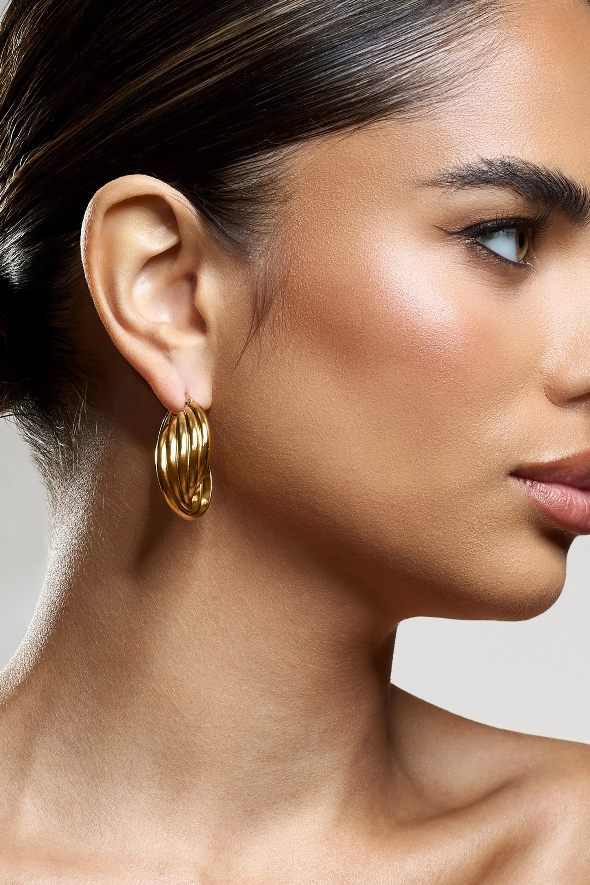 Indigo | Gold Chunky Twisted Hoop Earrings sold by Club L London product image thumbnail 2