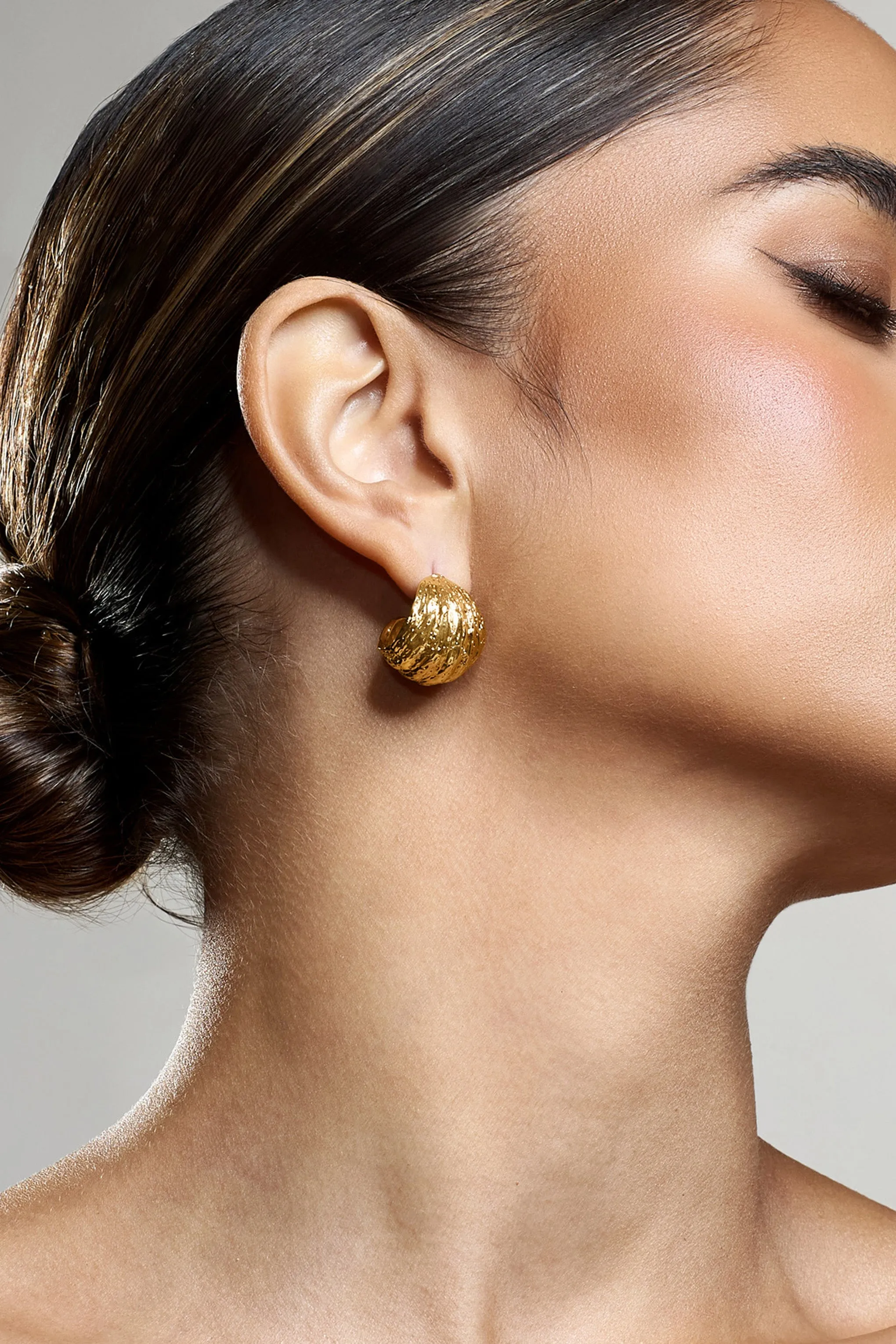 Christabel | Gold Textured Huggie Earrings sold by Club L London product image thumbnail 3