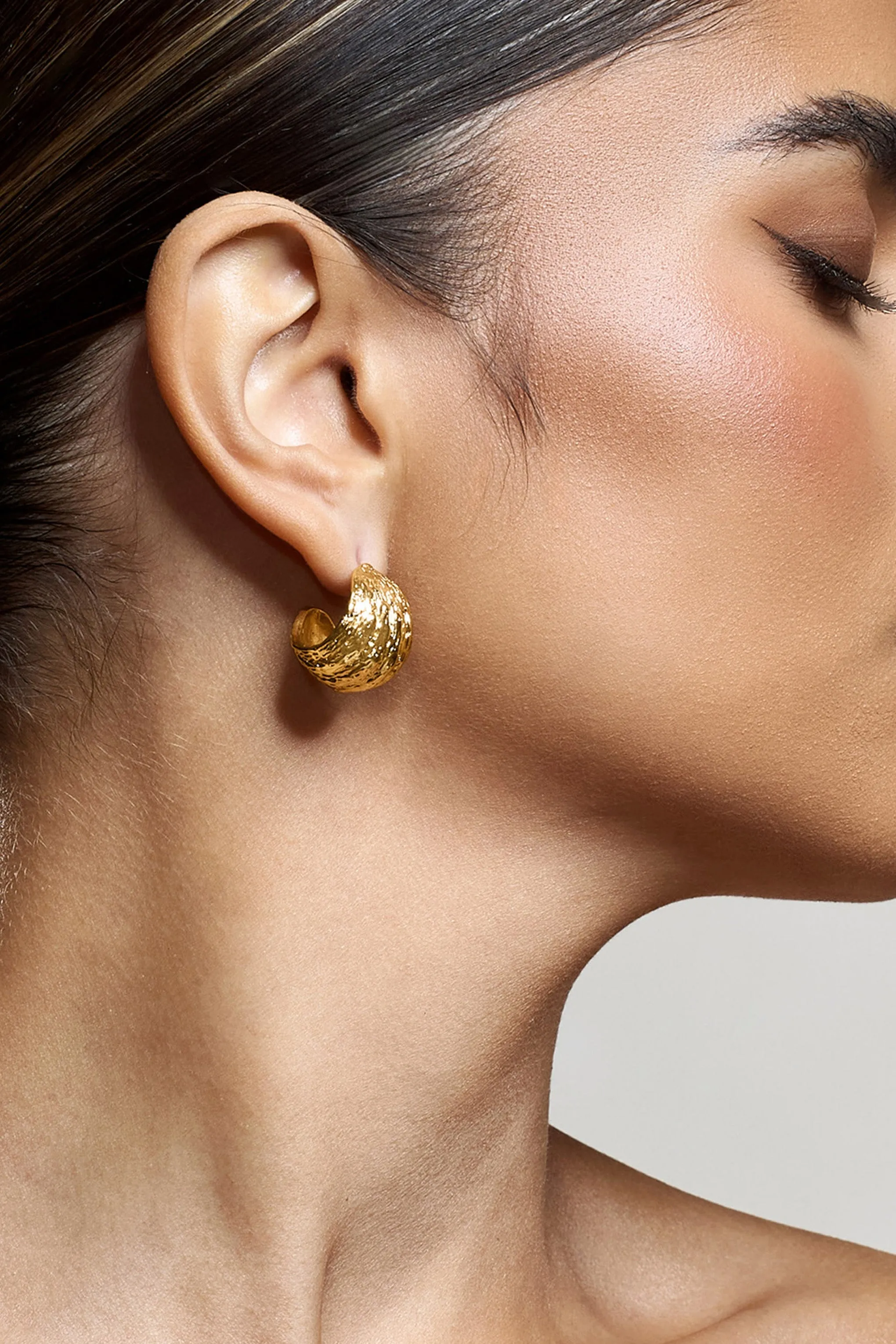Christabel | Gold Textured Huggie Earrings sold by Club L London product image thumbnail 4