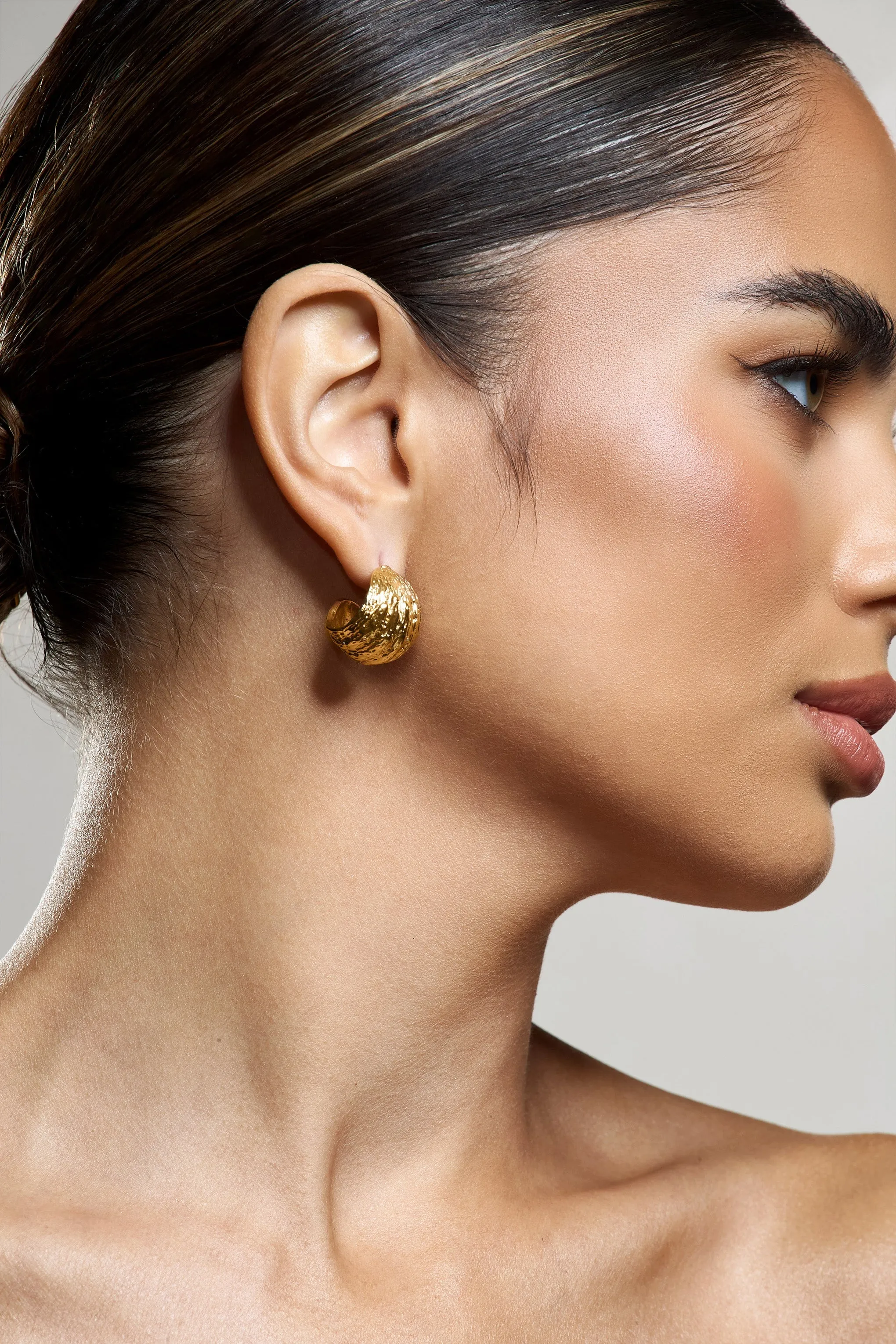 Christabel | Gold Textured Huggie Earrings sold by Club L London product image thumbnail 2