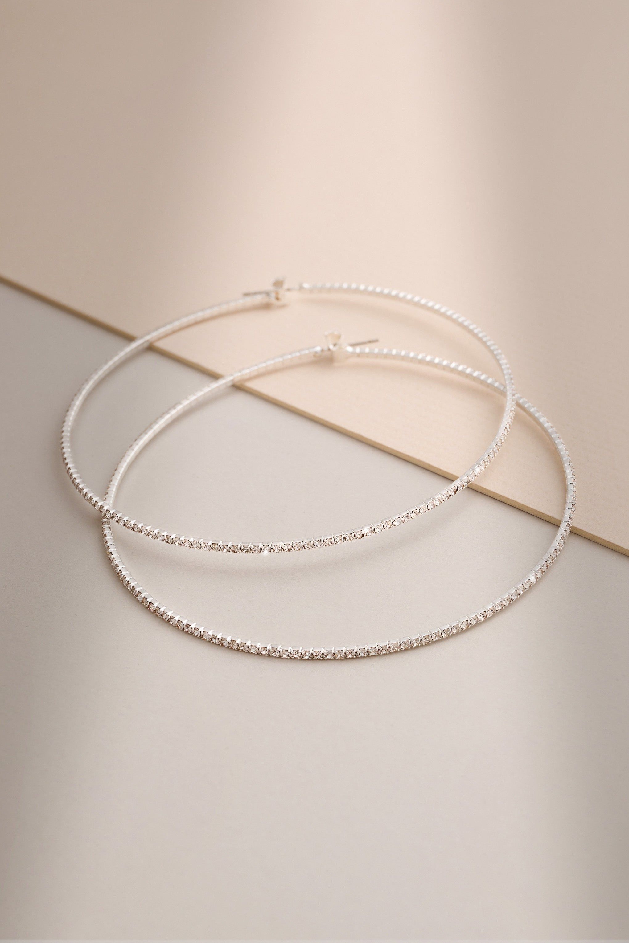 Rosey | Silver Diamante Thin Hoop Earrings sold by Club L London