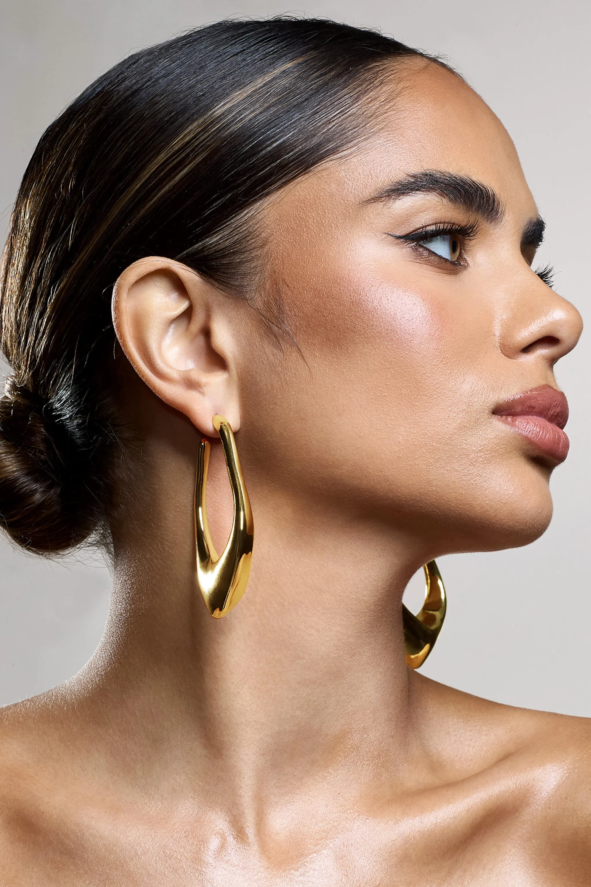 Tanzania | Gold Abstract Dangle Hoop Earrings sold by Club L London