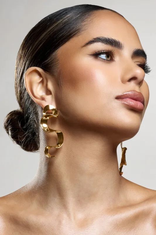 Outline | Gold Twisted Dangle Earrings sold by Club L London