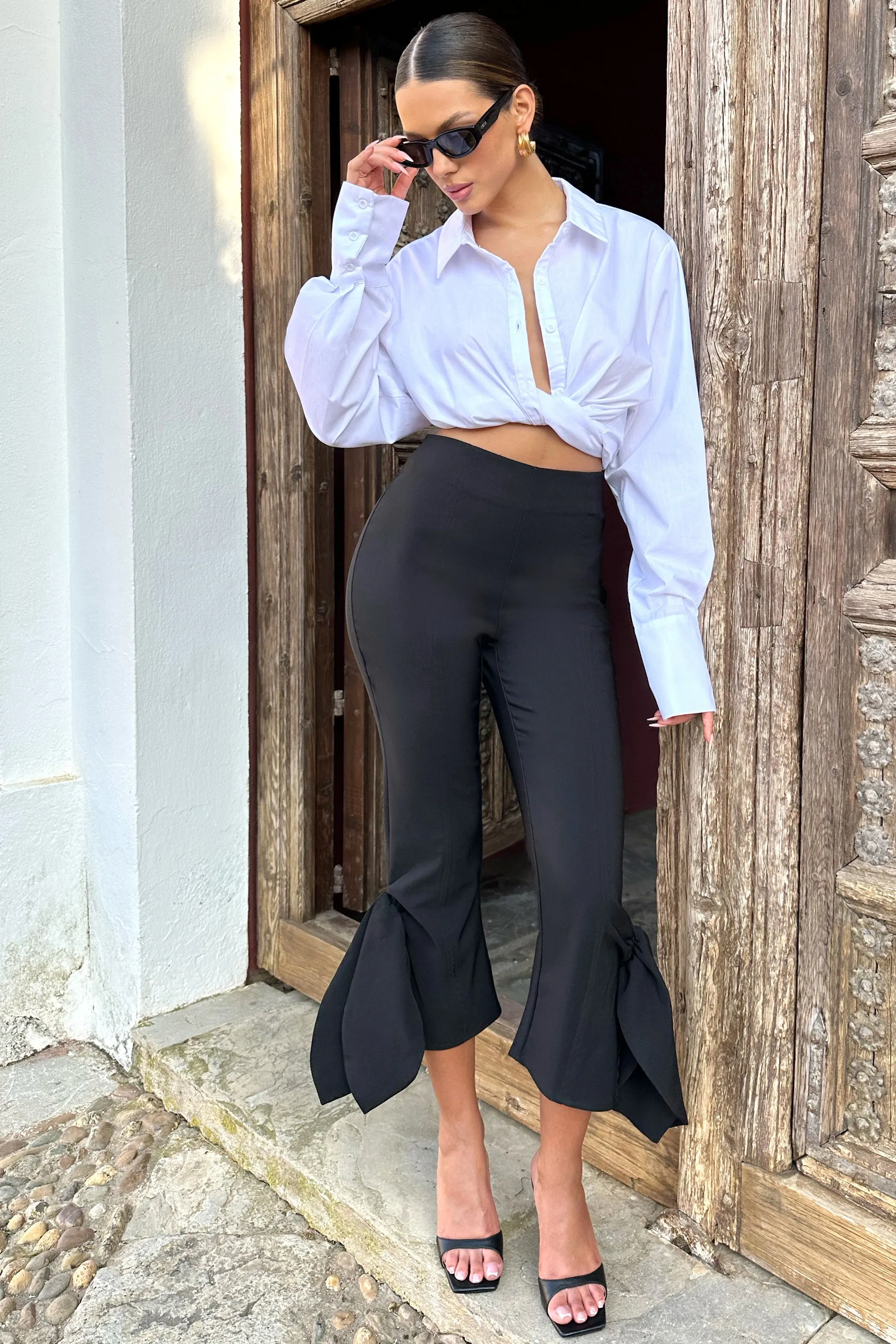 On Stage | Black Cropped Capri Pants With Knot Detail sold by Club L London